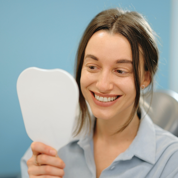 Happy patient after her porcelain veneers were placed in Tustin, CA.